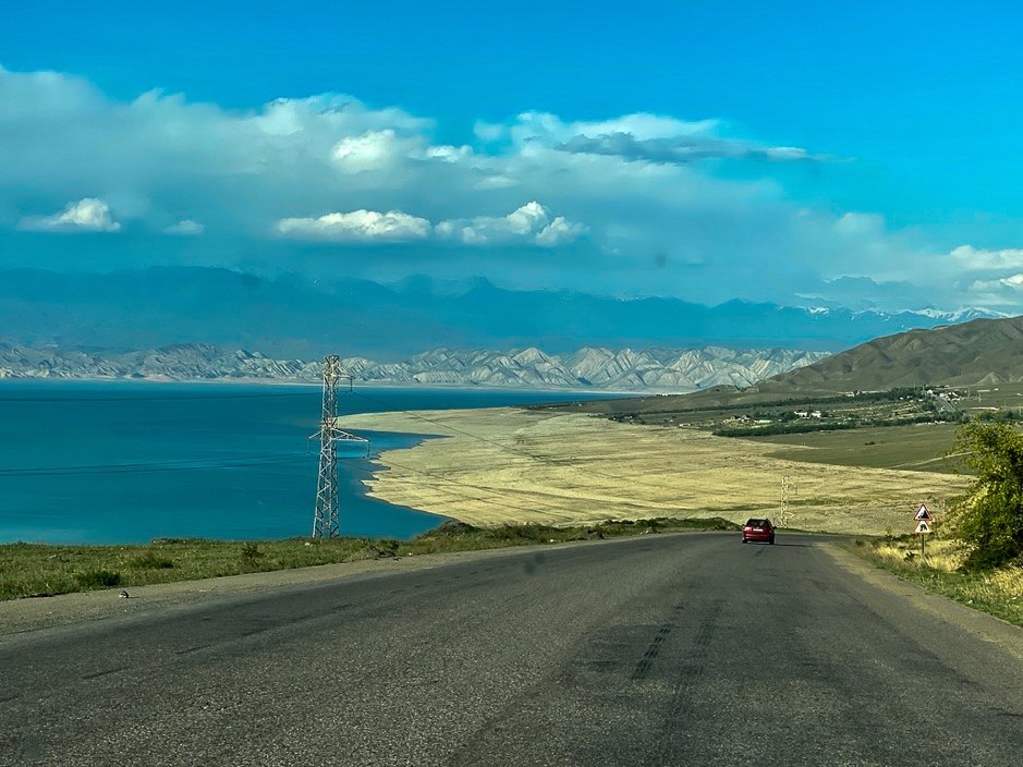 Toktogul reservoir with a transmission tower on the shoreline